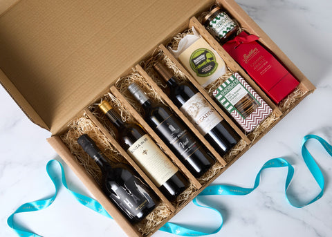 The Trip Around the World Hamper with four wines from Italy, Spain, California and Bordeaux, Knockanore cheddar, Sheridans crackers and chutney, and Butlers chocolates